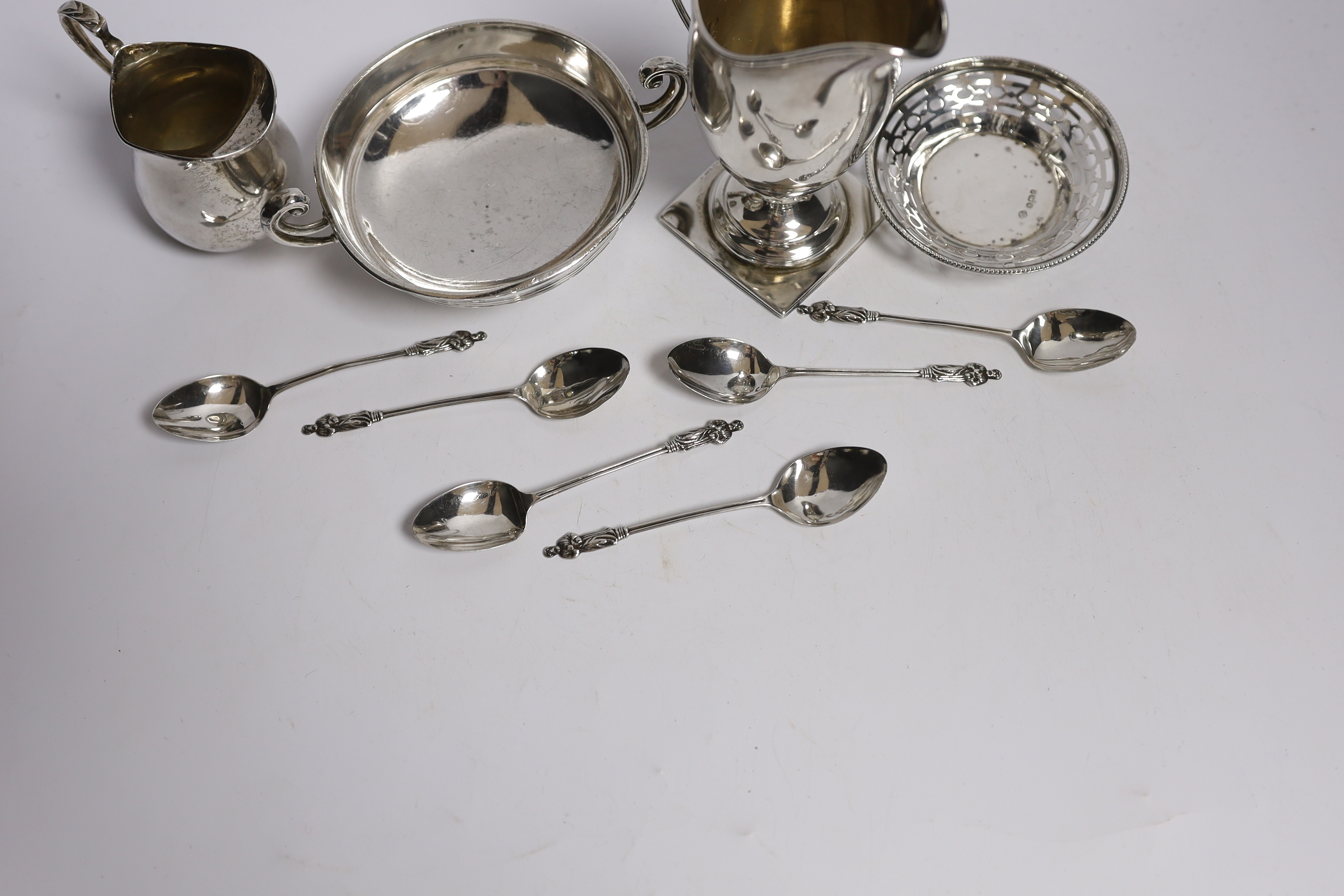 Two George V silver cream jugs, largest 12.5cm, a silver two handled pedestal bowl, a pierced small dish and set of six small silver coffee spoons.